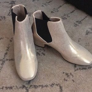 Brand New gold booties with black detail on sides